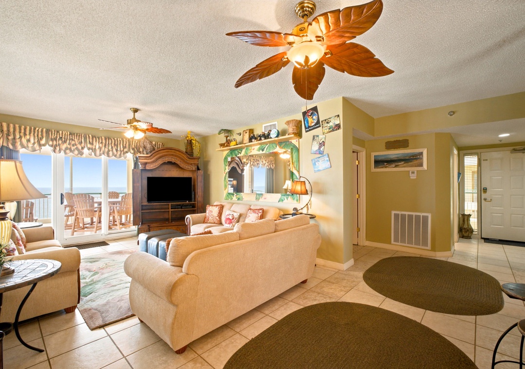 Beach Colony W13A- Settle into this bright, coastal living space with ocean breezes overhead. Your beachside retreat features comfy seating, tropical charm, and a balcony where the sea awaits just beyond those sunny doors.
