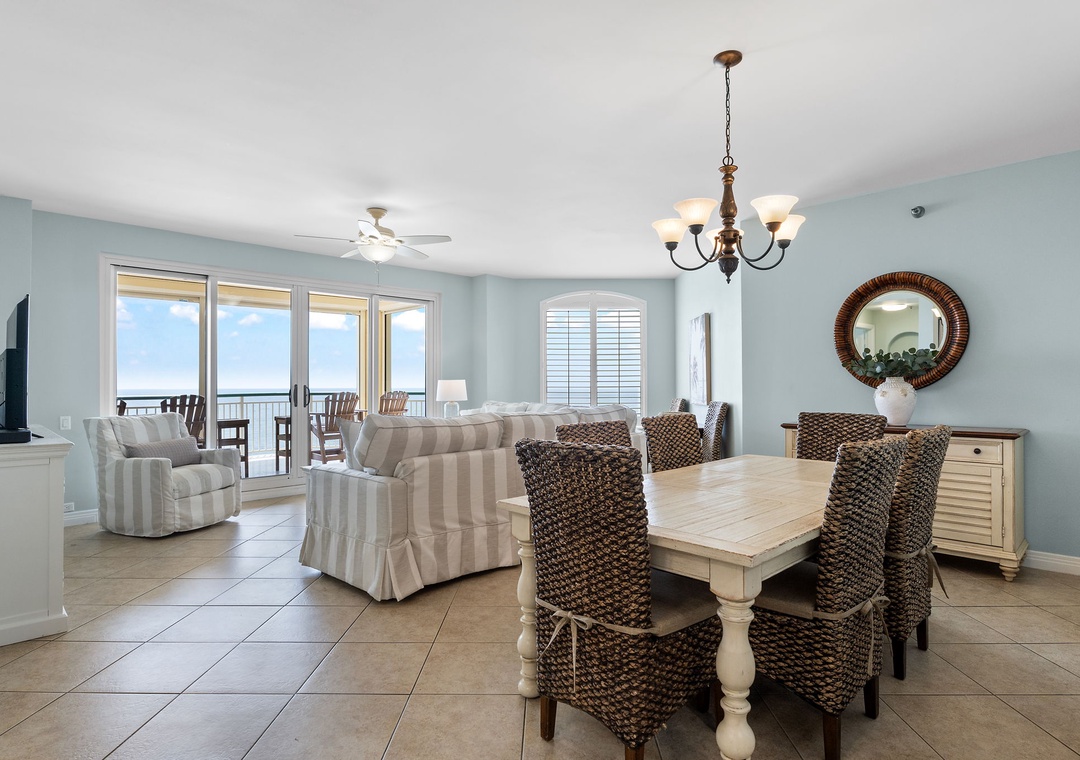 Beach Colony Tower 10C- Gather for meals with an ocean backdrop in this bright coastal dining space, styled with coastal charm and woven comfort.
