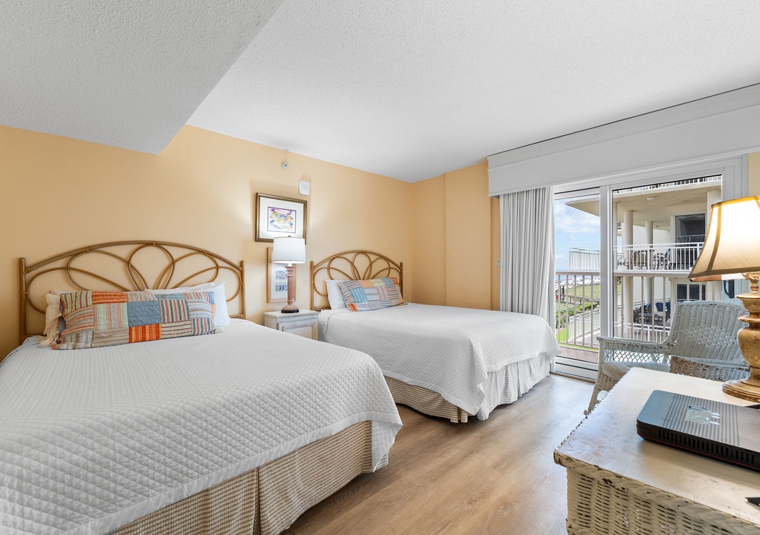 Sandy Key 338- Wake up to ocean breezes and coastal views from your bright, beach-inspired bedroom. Two comfy beds, cozy seating, and direct balcony access make this your perfect seaside escape.