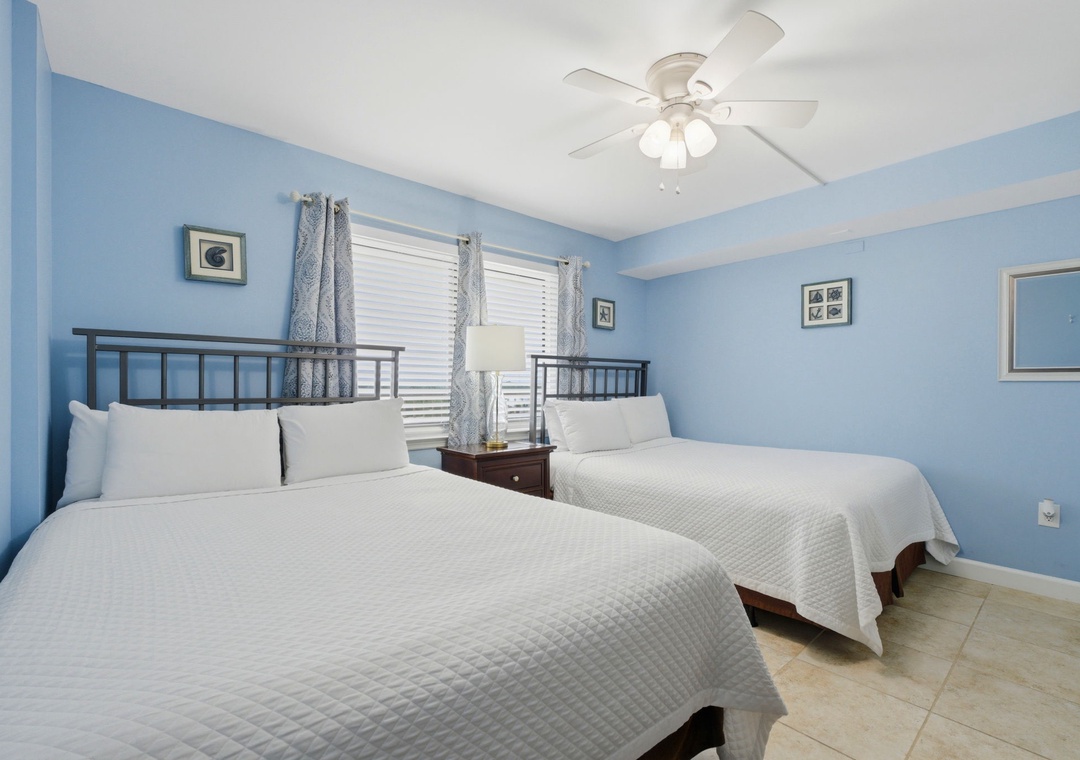 Sandy Key 637- Your restful bedroom features comfortable beds dressed in crisp linens, soothing blue walls, and a ceiling fan to keep you cool and relaxed throughout your stay.