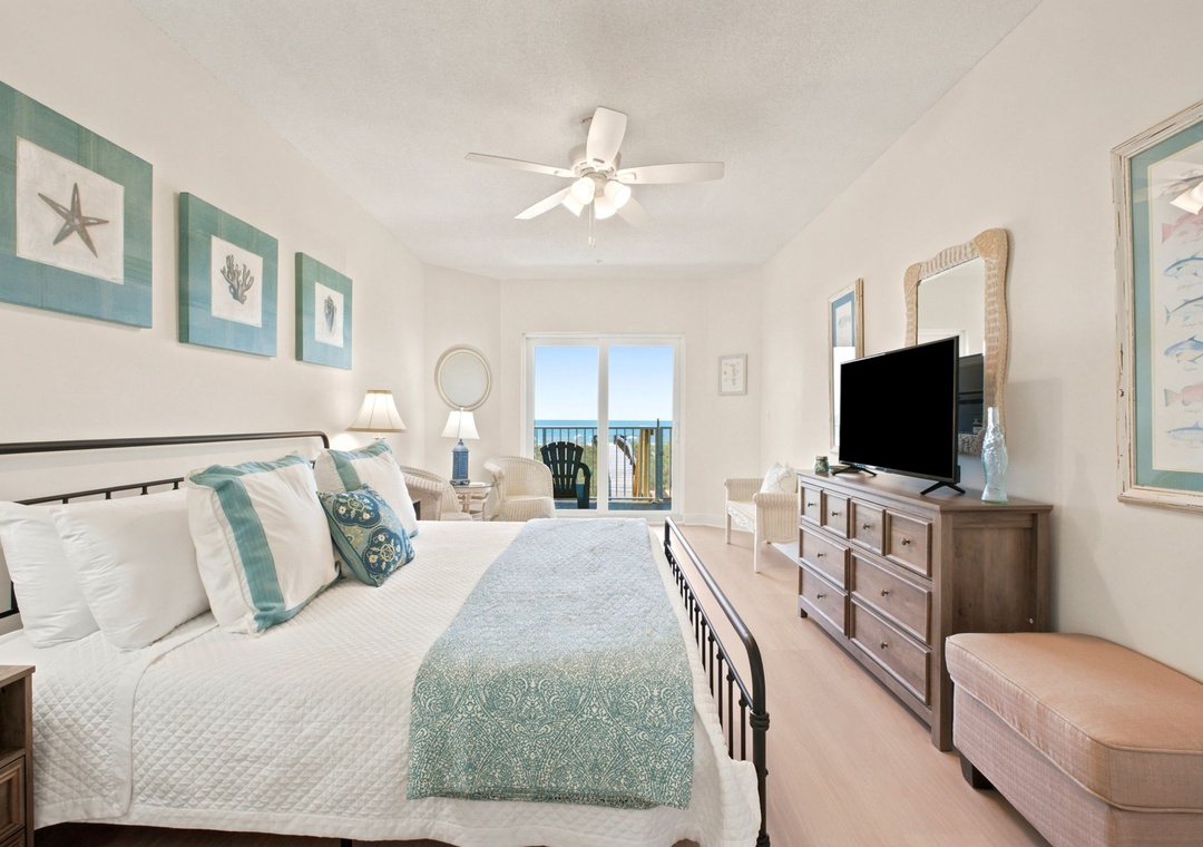 Your coastal-inspired bedroom offers peaceful vibes with soothing teal accents, a comfy bed, and your own balcony overlooking the water—perfect for restful mornings.