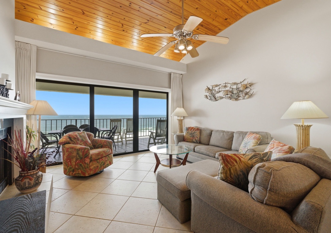 Shipwatch D803- Unwind in your coastal living space with stunning ocean views, cozy seating, and a warm wood ceiling. Glass doors open to your private balcony, inviting sea breezes in.