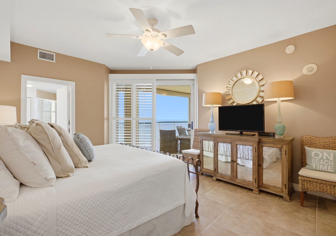 Beach Colony T PH1D- Wake up to ocean breezes and sunlight streaming through your balcony door. This serene bedroom offers plush bedding, coastal decor, and a private balcony where you can enjoy morning coffee overlooking the water.