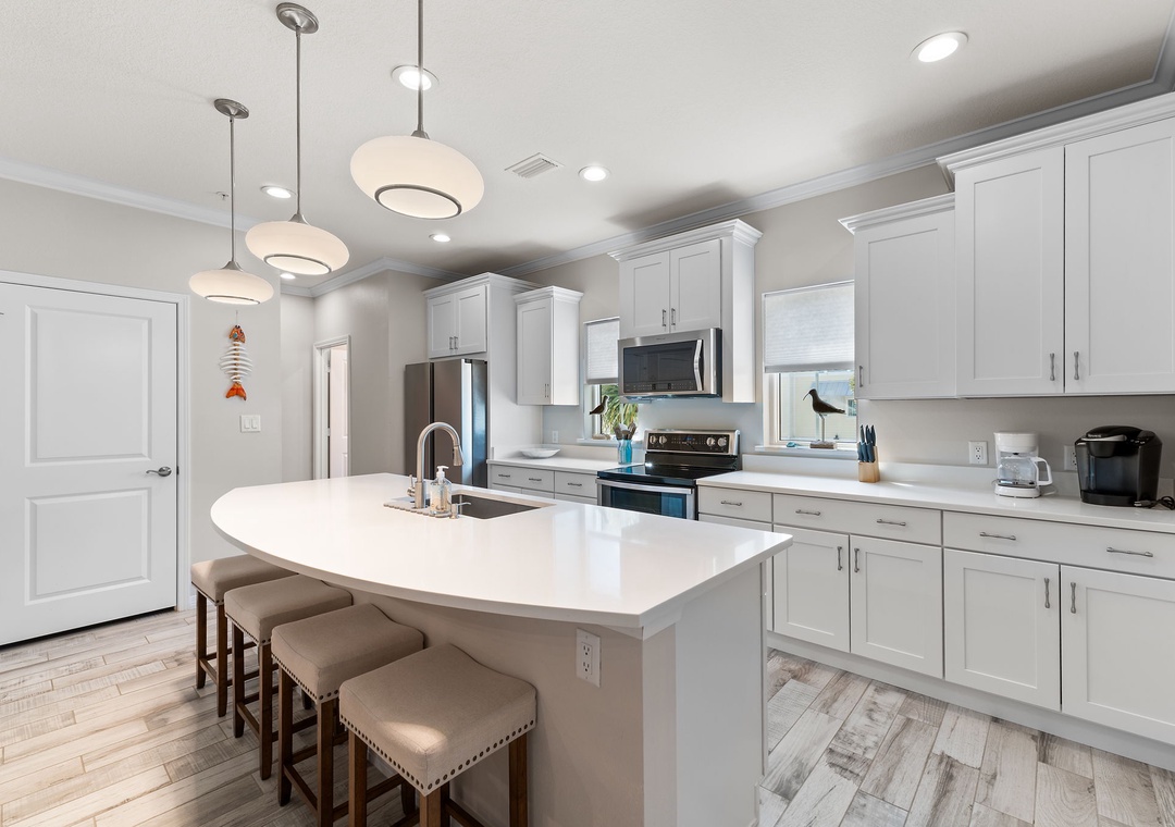 Turtles Nest- Step into your chef's dream with this bright, modern kitchen where sleek white cabinetry meets a spacious island—perfect for morning coffee or entertaining friends.