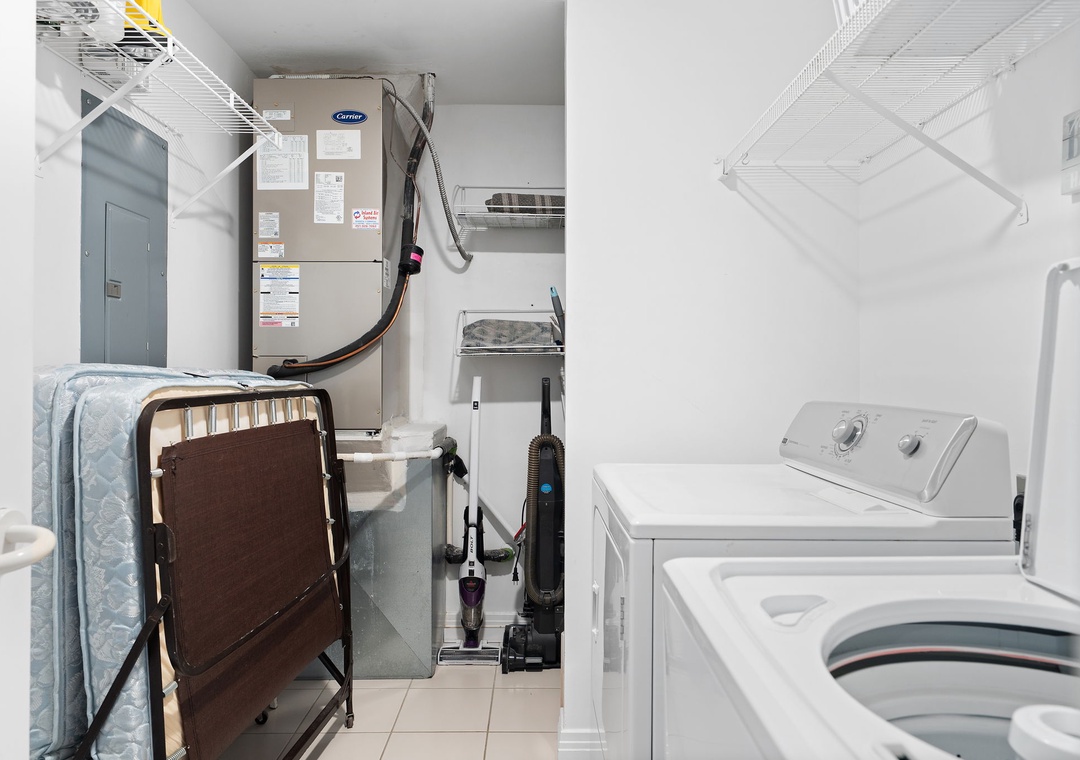 Beach Colony T14B- Your own in-unit washer and dryer make laundry effortless, with overhead shelving to keep essentials organized and within reach.