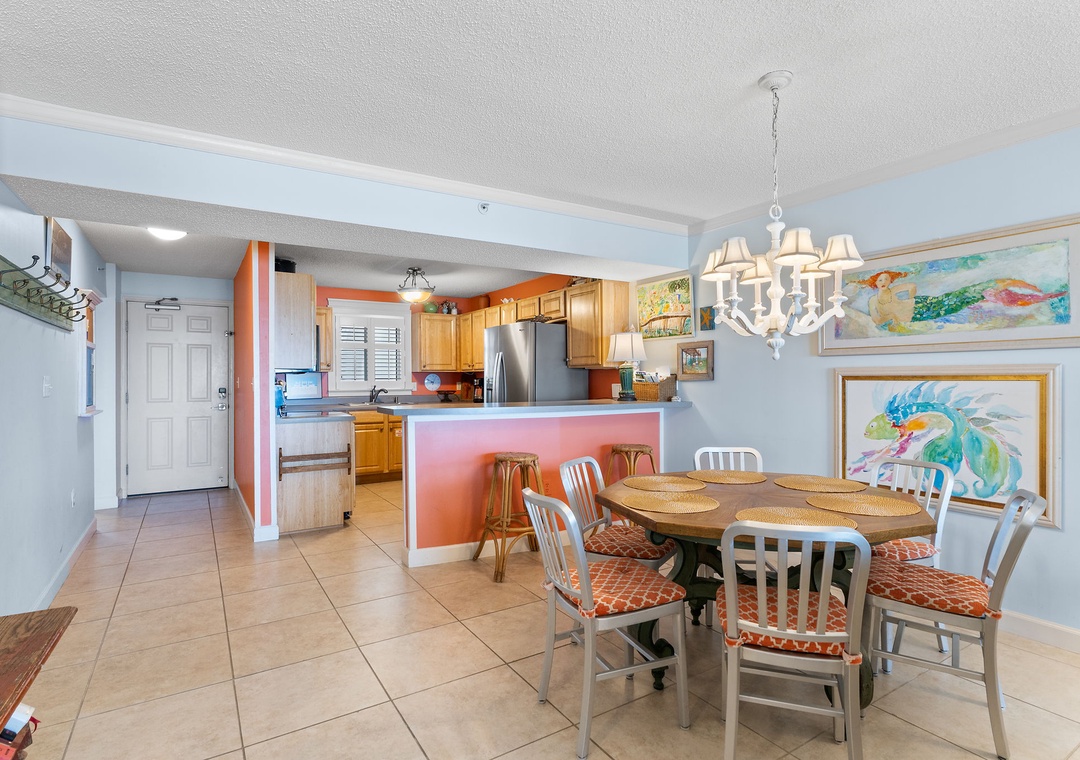 Sandy Key 338- Gather around your spacious dining table under a charming chandelier, with the fully-equipped kitchen just steps away. Bright, open spaces make mealtime easy and inviting.