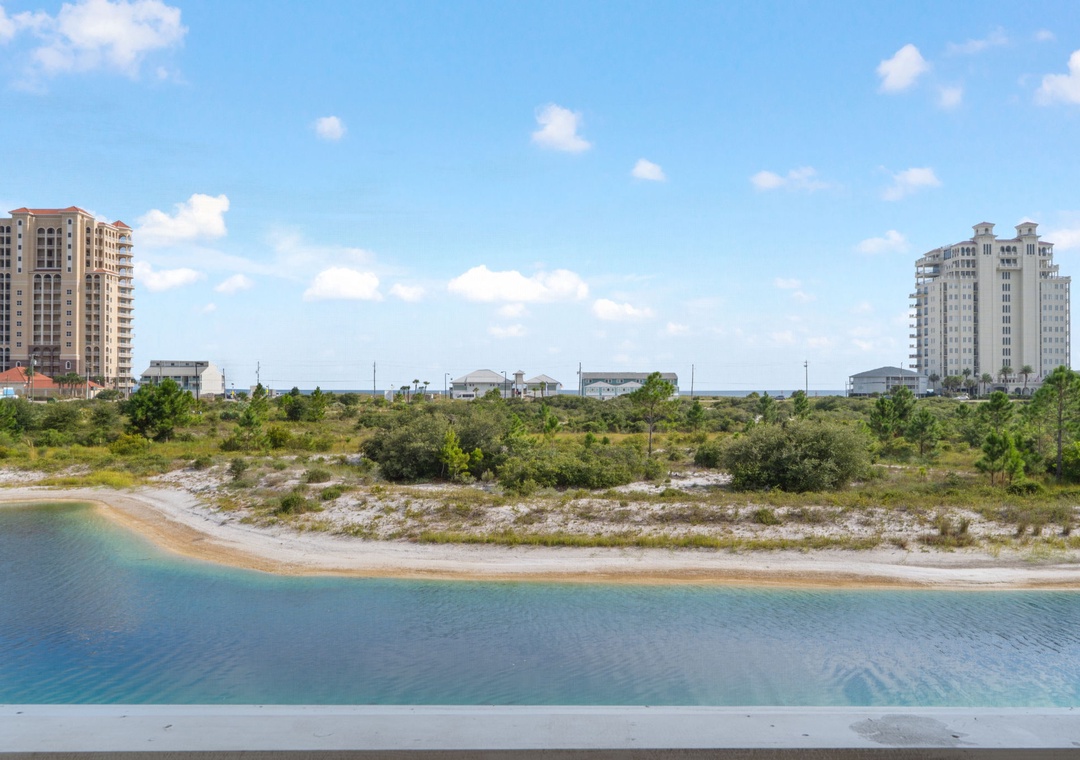 Saltwater & Sunsets- A tranquil coastal setting featuring natural dunes and native vegetation with nearby residential towers. The property is situated within a peaceful, low-density area offering easy access to the beach and waterfront.
