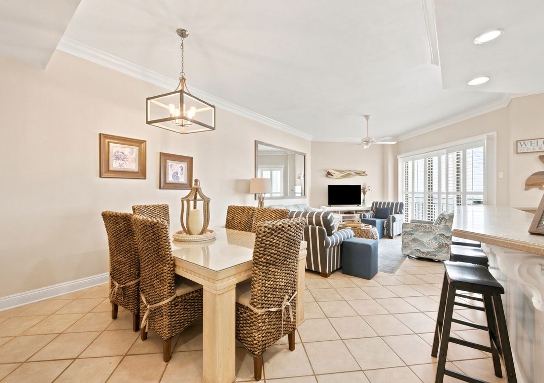 SeaChase 1104C-Picture yourself gathering around the dining table with loved ones, sunlight streaming through shuttered windows as coastal breezes drift in. This bright, open-concept space blends dining and living seamlessly for memorable moments together