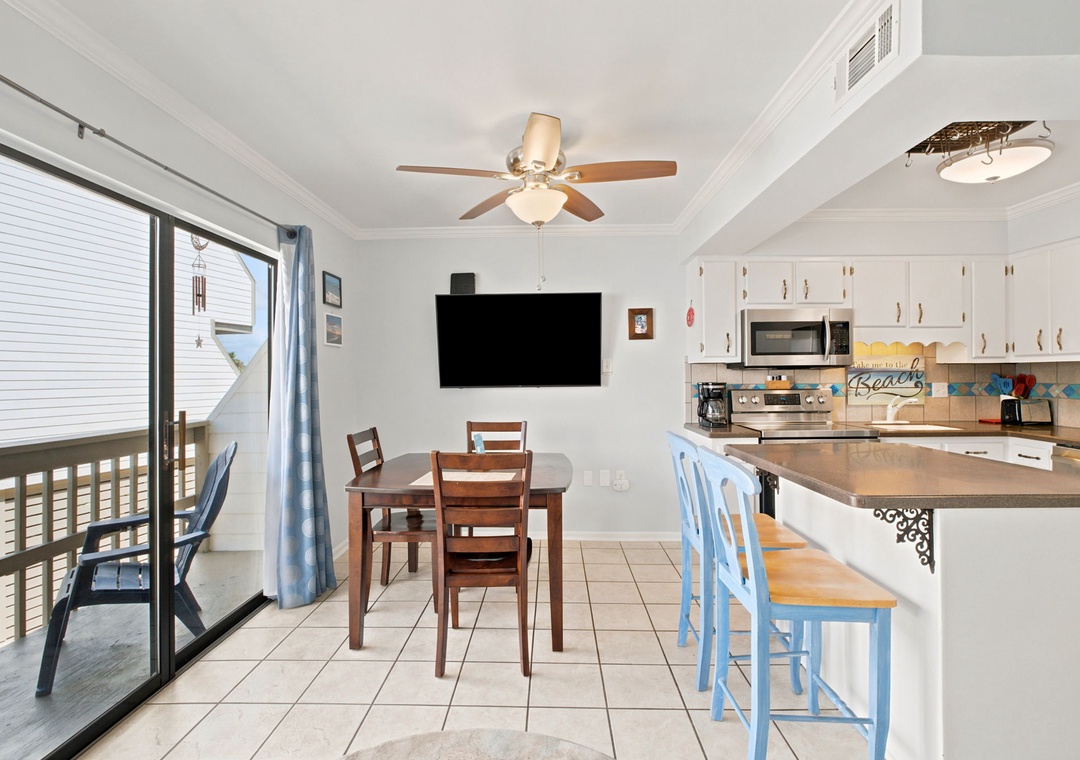 Gather around the dining table or perch at the cheerful kitchen island as natural light pours through the balcony doors. Your beachy escape awaits, complete with breezy ceiling fan and fully equipped kitchen to make every meal memorable.