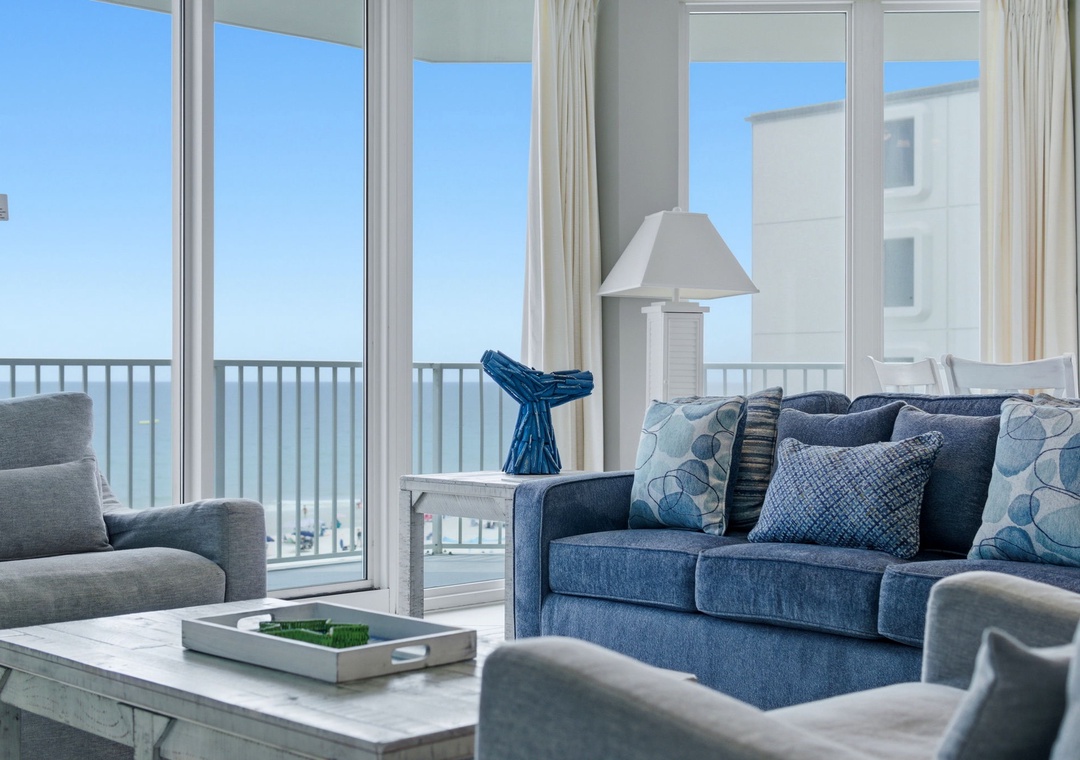 Lighthouse 418- Sink into coastal comfort in your living room, where soft blues and thoughtful touches create the perfect seaside retreat for morning coffee or sunset relaxation.