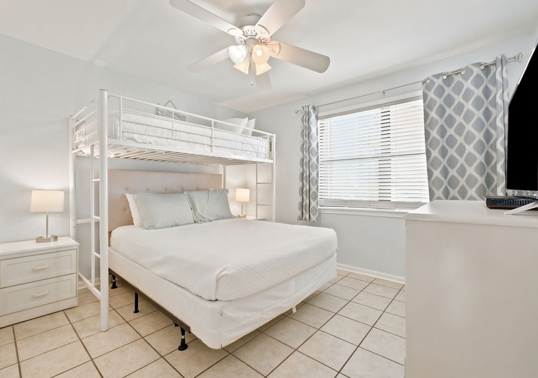Rest easy in your peaceful bedroom with a queen bed, bunk above for extra guests, and ceiling fan to keep you cool. Your private TV and cozy lighting make evenings yours to unwind.