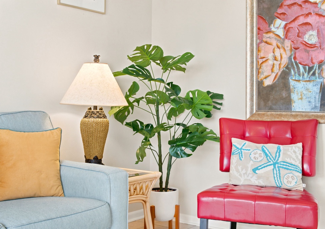 Sink into plush seating with cheerful coastal touches, where vibrant artwork and tropical greenery create your perfect corner to unwind after exploring.