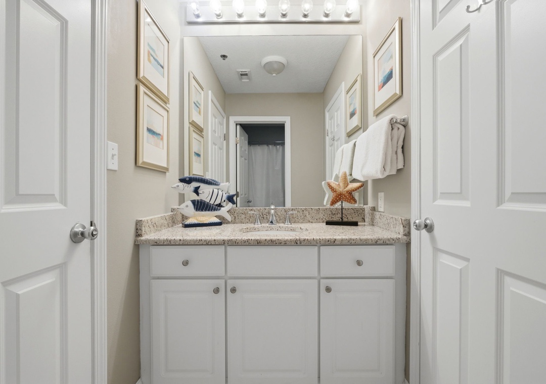 Lighthouse 418- Freshen up in your stylish coastal-themed vanity area, complete with plush towels, beach-inspired décor, and thoughtful lighting—a perfect spot to start your mornings.
