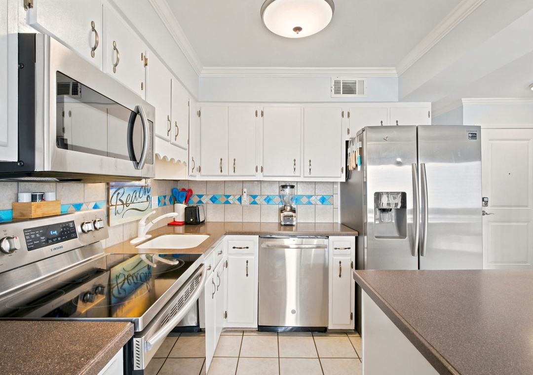 Your fully-equipped kitchen awaits with stainless steel appliances, generous counter space, and coastal-themed accents that invite you to whip up your favorite meals in style.