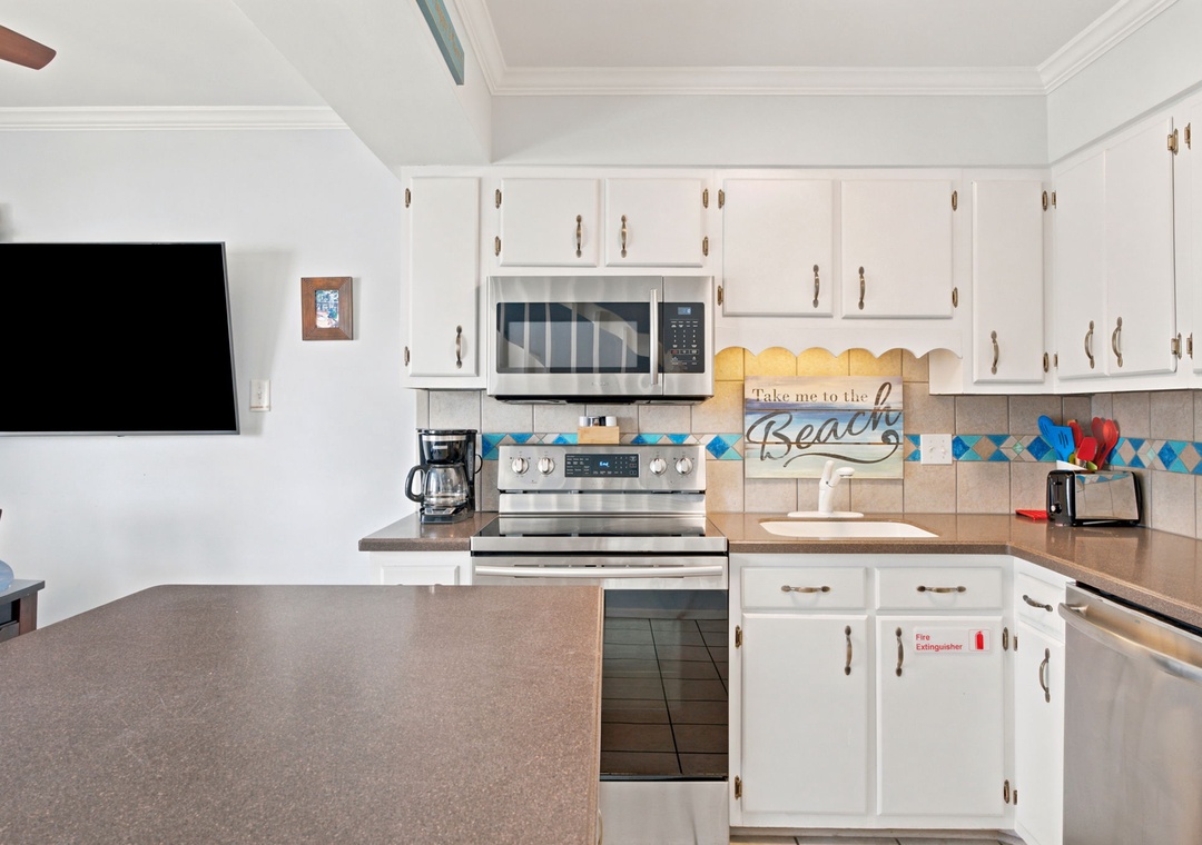 Your fully-equipped kitchen features granite countertops, stainless appliances, and cheerful beach-themed touches—perfect for preparing family meals together during your stay.