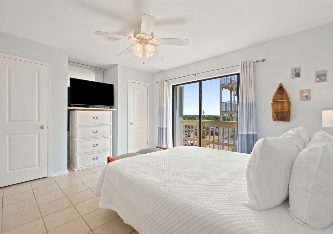 Wake up to waterfront views from your serene bedroom, where nautical touches and plush bedding invite you to unwind by the marina's peaceful scenery.