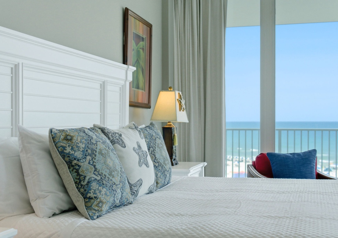 Lighthouse 418- Wake up to stunning ocean views framed by your private balcony, where plush bedding and coastal decor create the perfect beach retreat.