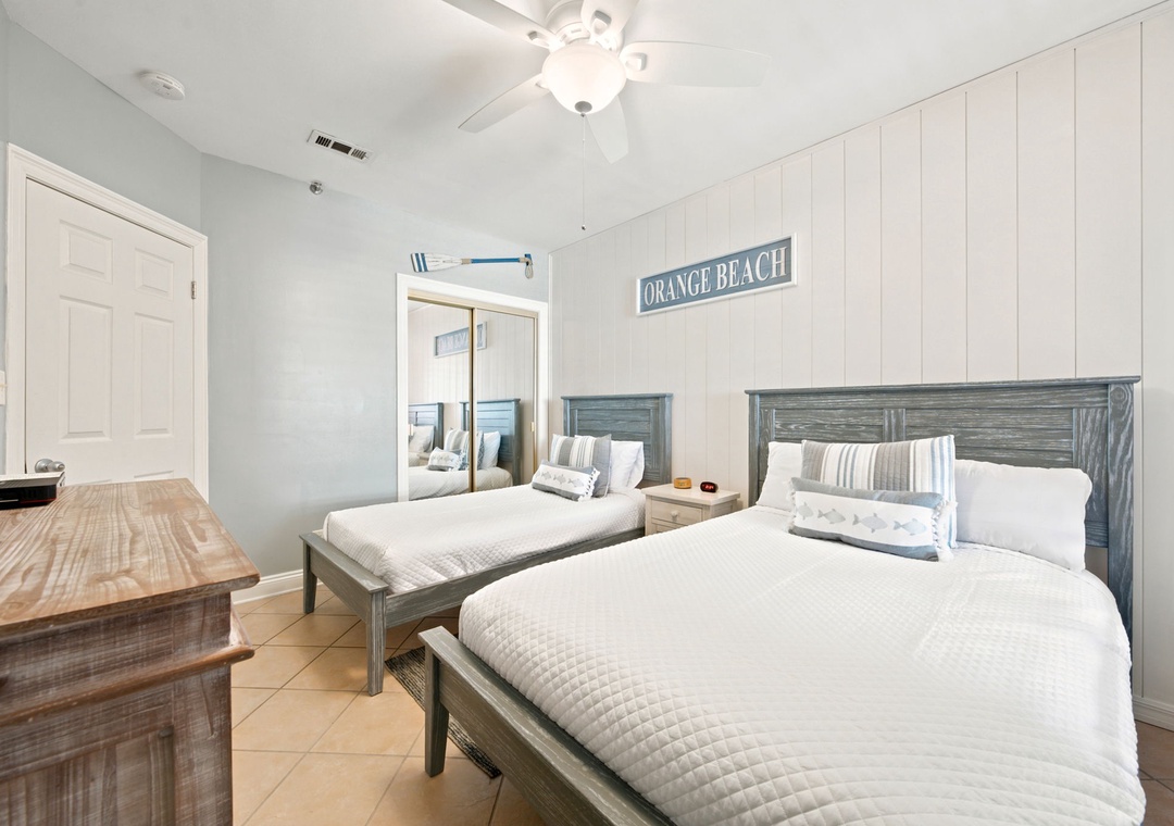 SeaChase 1104C- Drift off in this serene coastal bedroom with two plush beds, beach-inspired décor, and a ceiling fan to keep you cool after your sun-soaked adventures.