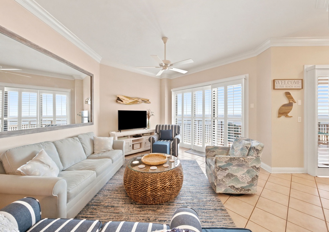 SeaChase 1104C- Settle into this breezy coastal living room where soft whites and ocean blues blend perfectly. Your living space opens to a private balcony, promising sunrise coffee and sunset toasts with views that stretch beyond the horizon.