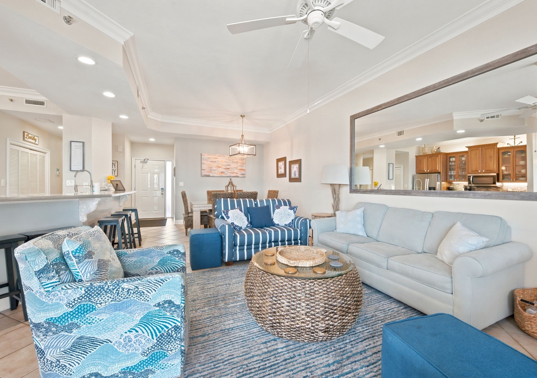 SeaChase 1104C-Sink into plush coastal-inspired seating and unwind in your open-concept living space, where natural light, beachy blues, and woven textures create a breezy, welcoming retreat perfect for your group getaway.