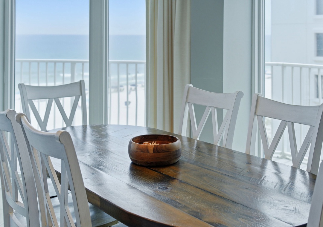 Lighthouse 418- Picture yourself enjoying meals at this charming coastal dining table, with stunning sea views stretching across the horizon through wide glass doors leading to your private balcony.