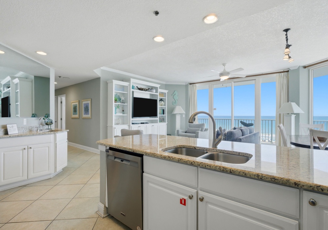 Lighthouse 418- Your open kitchen flows into a bright living space with stunning ocean views framing every moment, blending comfort with coastal elegance.