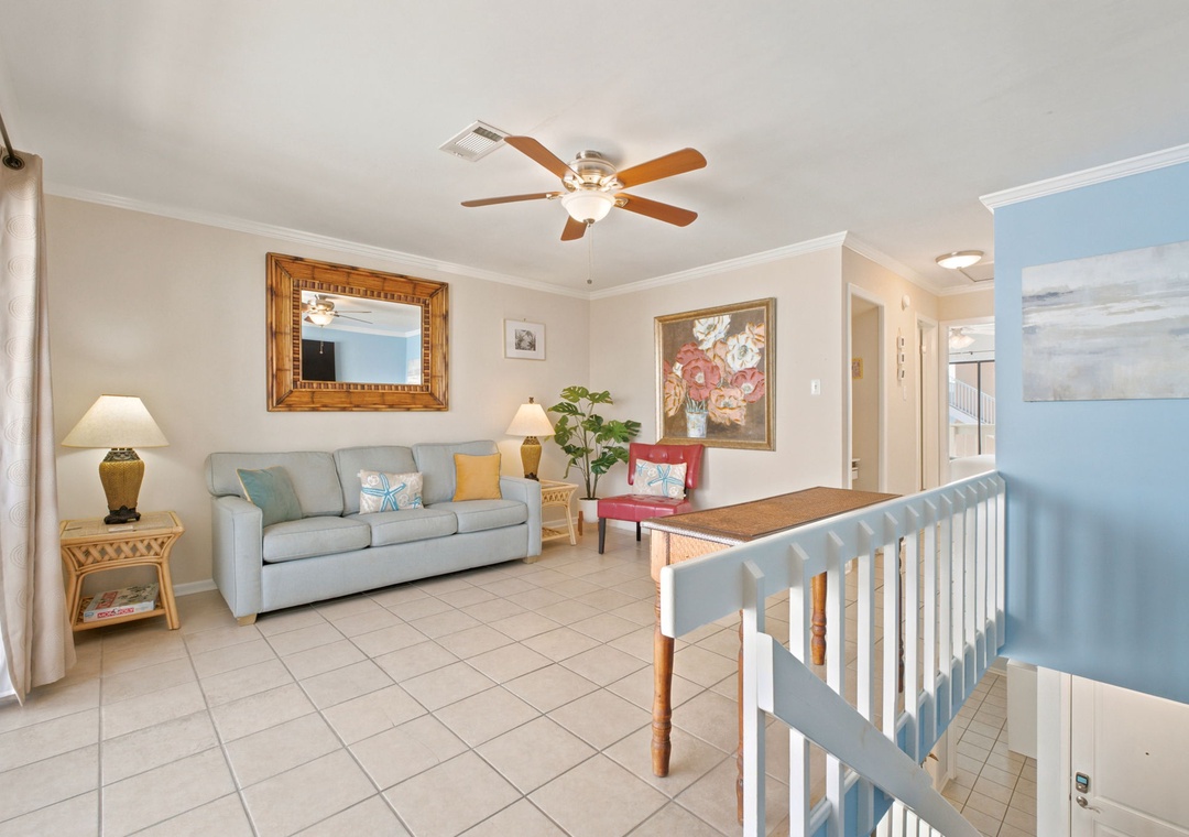 Relax in your bright living space with coastal charm—soft seating, cheerful accents, and a welcoming layout perfect for unwinding after beach adventures.