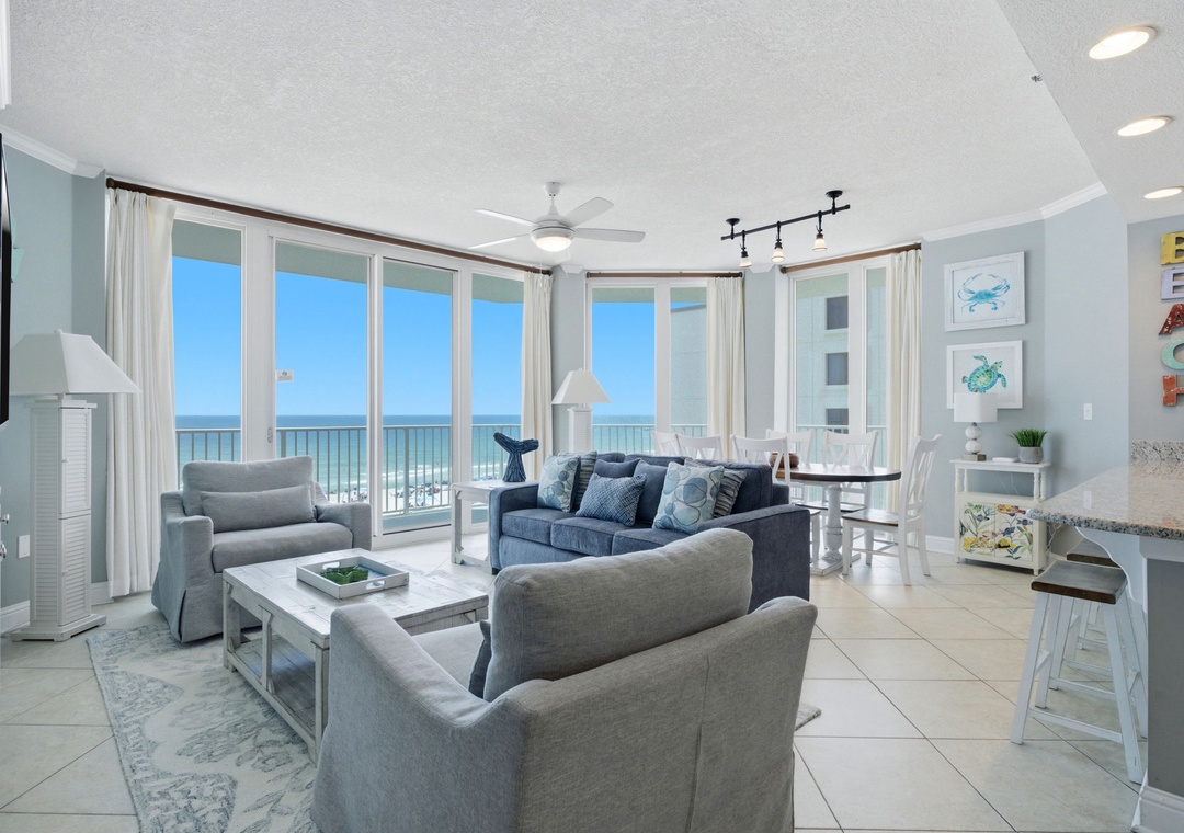 Lighthouse 418- Unwind in your coastal living room with breathtaking ocean views through expansive windows. Comfortable seating invites you to relax while gentle waves and salty breezes create your perfect beach retreat.