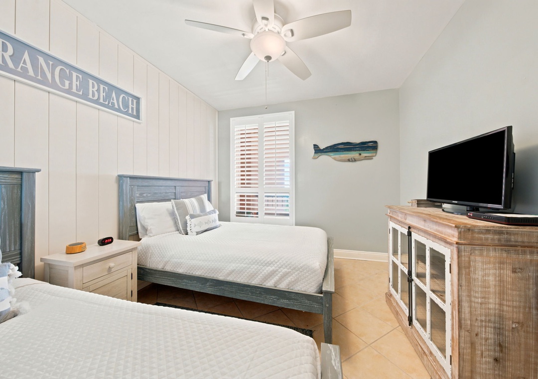 SeaChase 1104C- Unwind in your coastal-inspired bedroom with two comfortable beds, breezy ceiling fan, and flat-screen TV—perfect for restful nights after beach adventures.
