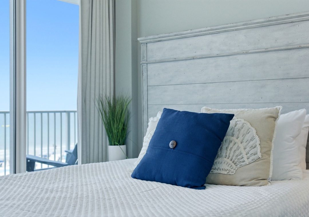 Lighthouse 418- Wake to the sound of waves through your private balcony doors, where coastal blues meet crisp white linens. Your beachside retreat awaits with calming ocean breezes and endless sea views just steps away.