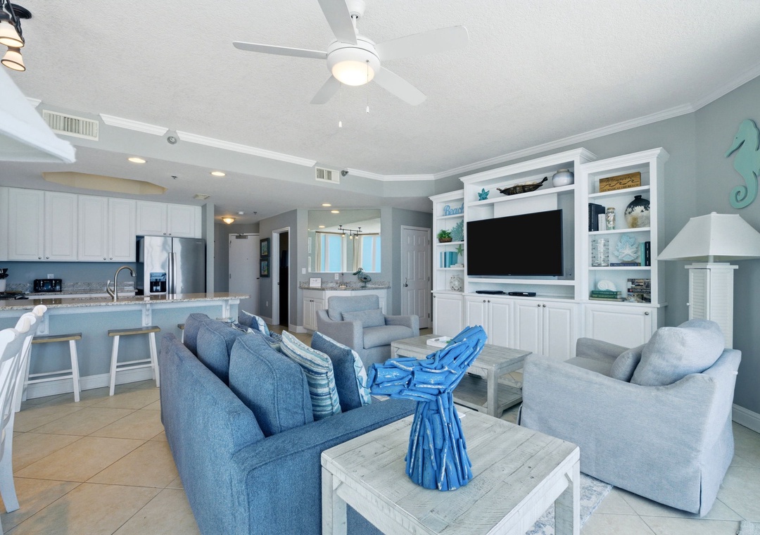 Lighthouse 418- Step into your coastal escape, where airy blues and whites create a breezy, open atmosphere. Relax on soft seating, cook in your fully equipped kitchen, and enjoy modern comforts blended with beachy charm throughout.
