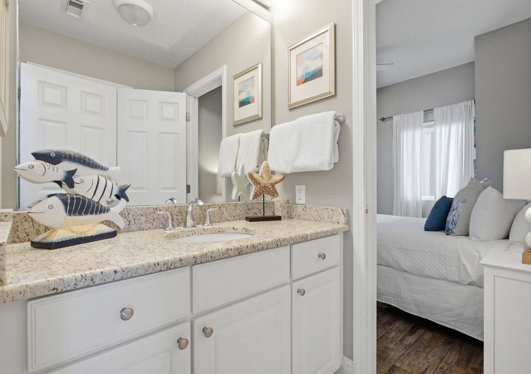 Lighthouse 418- Freshen up in your private ensuite with coastal charm, granite counters, and plush towels—steps from your comfortable bedroom retreat.