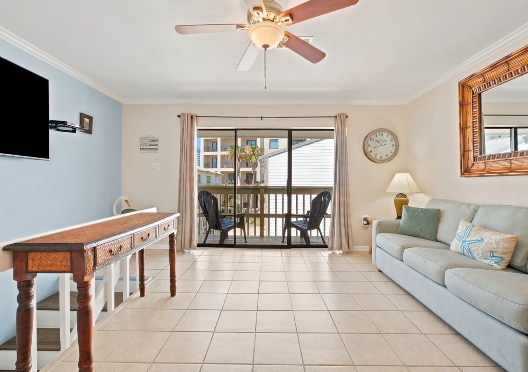 Unwind in this airy living room with soft coastal tones, comfortable seating, and a private balcony that invites fresh breezes and peaceful moments.