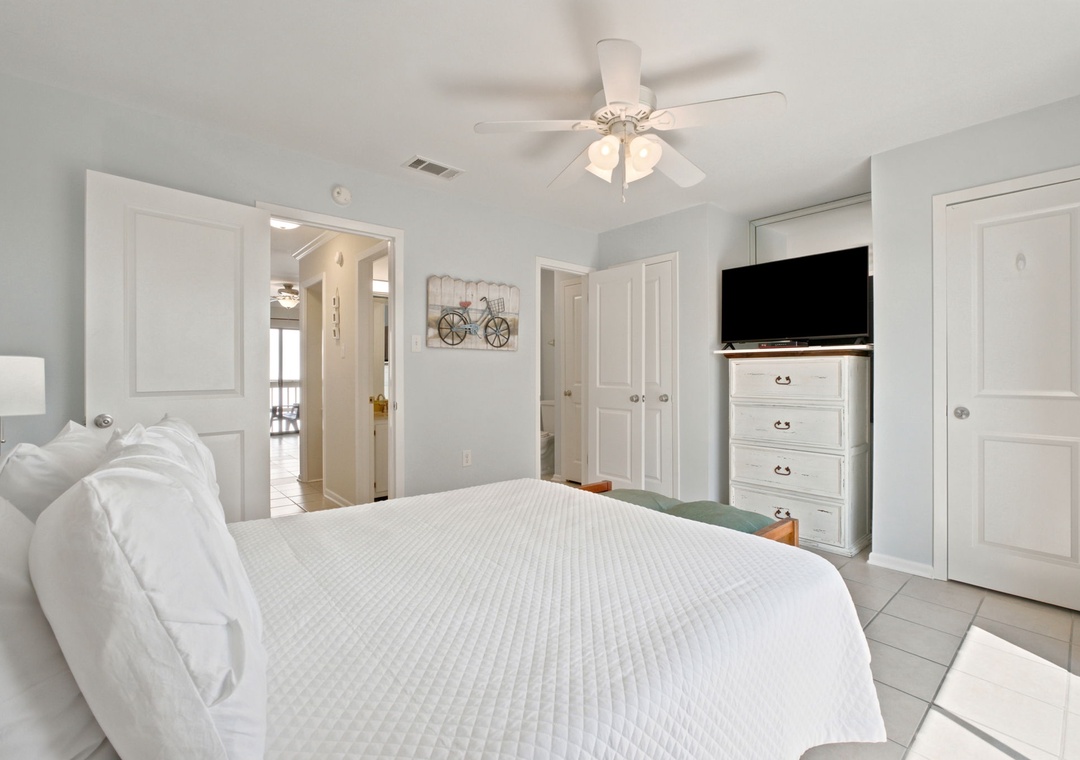 Settle into your serene retreat with plush linens, a ceiling fan, and thoughtful touches like a flat-screen TV and ample storage—your peaceful coastal escape awaits.