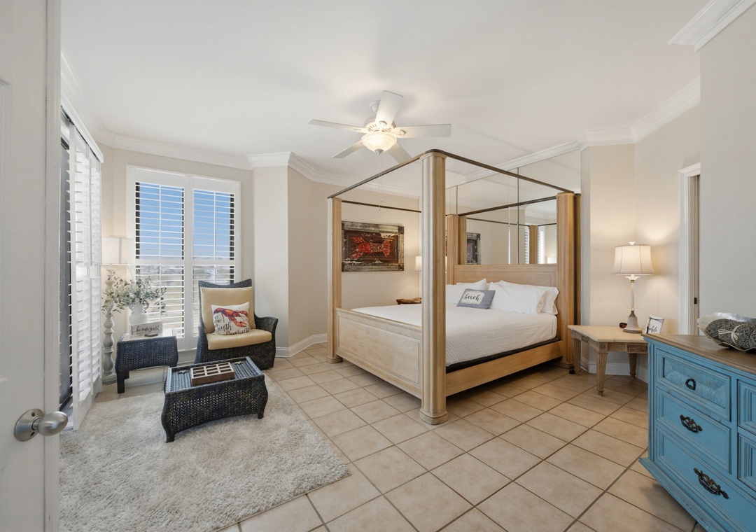 SeaChase 1104C- Retreat to your private sanctuary featuring a statement canopy bed, ceiling fan, and bright natural light. Cozy seating by the window creates the perfect reading nook.
