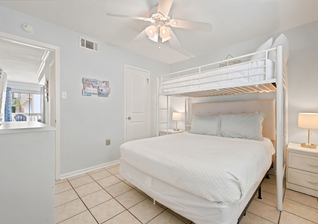 Your bright bedroom offers crisp white linens, clever sleeping space, and a gentle ceiling fan—perfect for drifting off after a day at the beach.