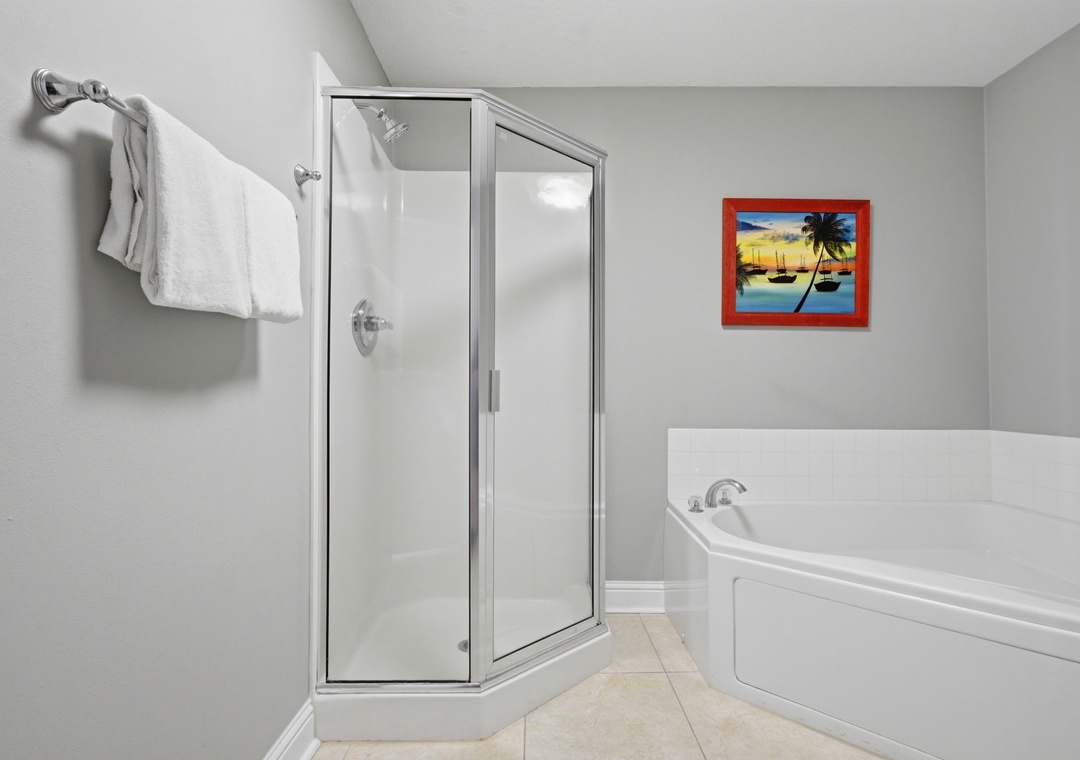 Lighthouse 418- Your private bathroom offers a spacious walk-in shower and soaking tub—perfect for unwinding after a day of adventure or relaxing before your evening out.