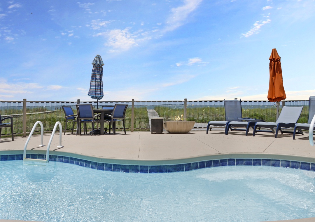 Beach Front Swimming Pool with Lots of Furniture