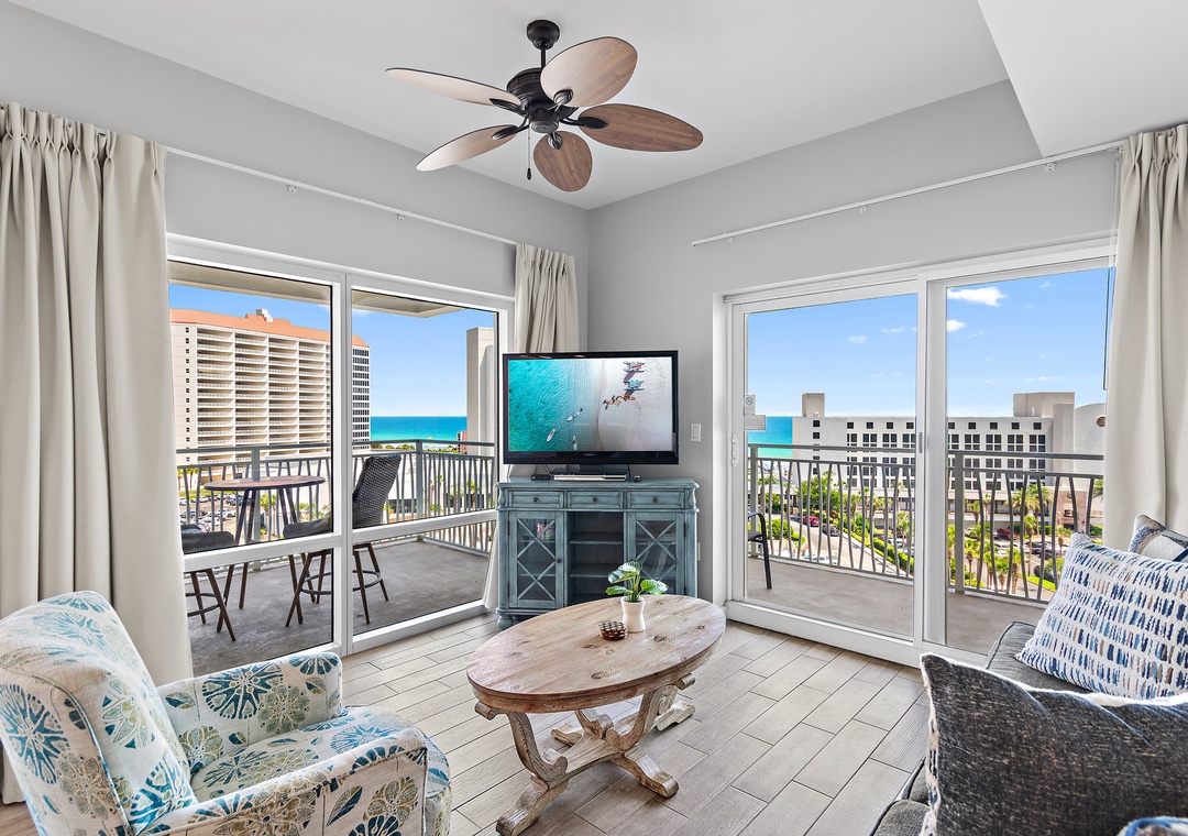 Relax in the spacious living area with balcony access and coastal scenery
