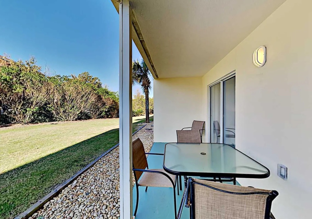 Private patio seating overlooking the landscaped grounds