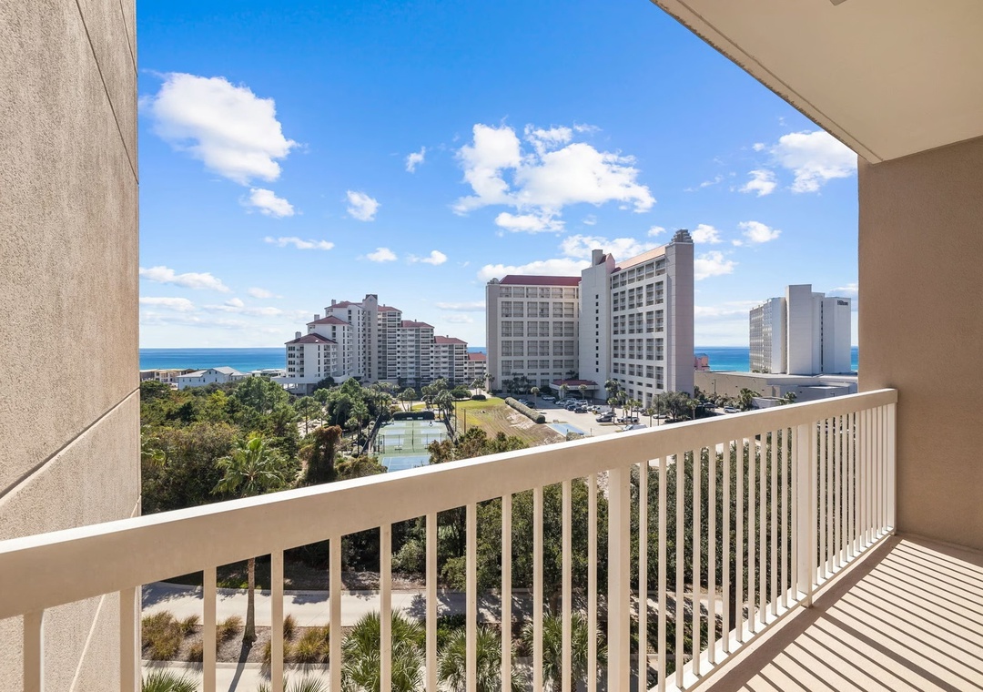 Private balcony overlooking the resort grounds with beautiful Gulf views in the distance