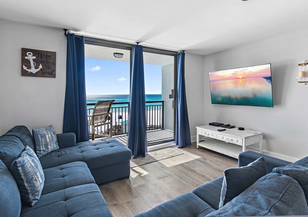 Living room with flat-screen TV and balcony access