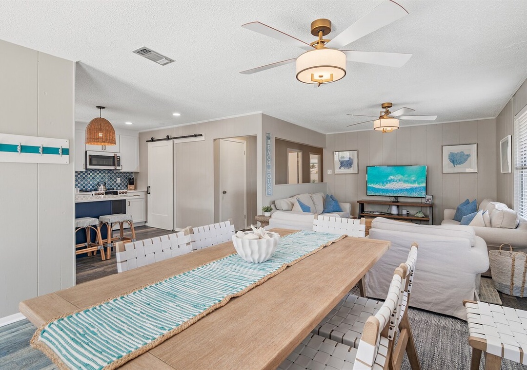 This open-plan space is ready for dinner parties at the big wooden table and movie nights on the comfy white couches