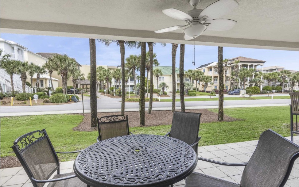 Enjoy your private covered patio with outdoor dining just steps from the beach access.