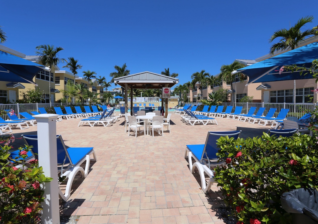 Large Pool Deck with Table and Chairs - Barefoot Beach Resort