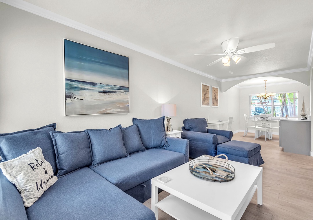 Comfy Couch and Chair in Living Room with Large Screen Smart TV