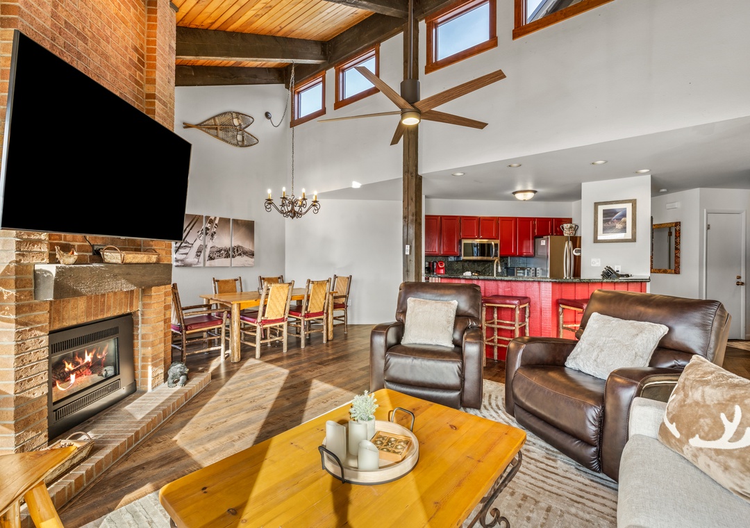 Unwind in your spacious living area with soaring ceilings, cozy fireplace, and open kitchen perfect for family gatherings.