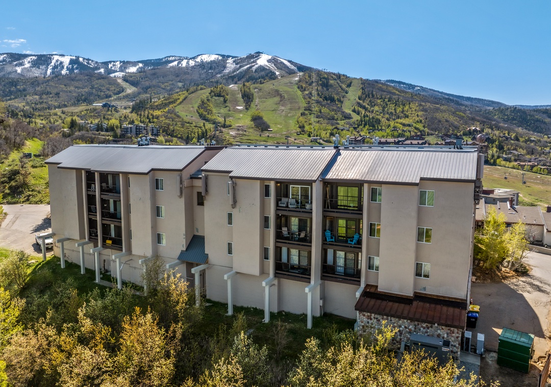 A multi-story vacation rental property nestled at the base of a renowned ski mountain, offering convenient access to seasonal outdoor activities and scenic mountain surroundings.