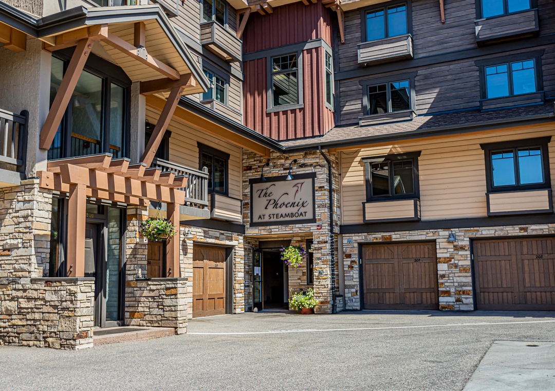 The Phoenix at Steamboat offers a welcoming entrance with charming mountain architecture, stone accents, and convenient garage access for your arrival.
