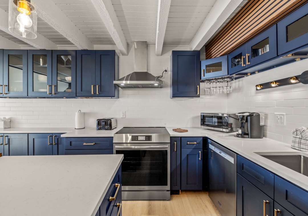 Your gourmet kitchen features navy blue cabinets, and stainless steel appliances for memorable culinary adventures.